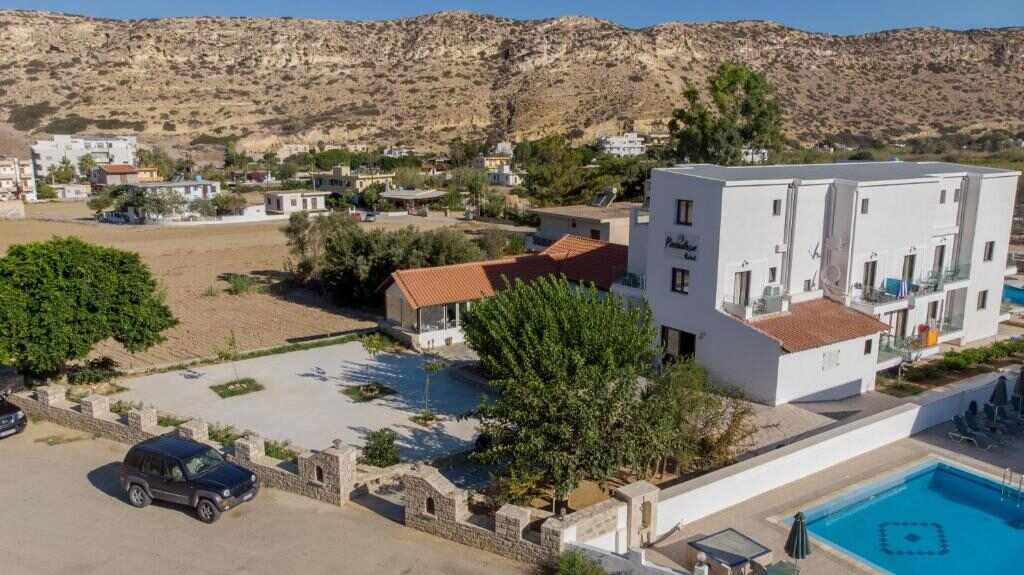 Paradise Matala Hotel with its pool and garden below the hills of Matala, Crete